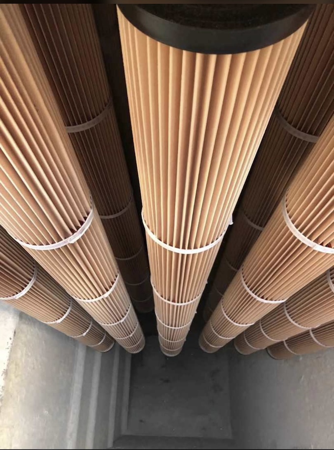 A row of long pleated cartridge filters.